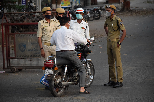Bharuch, Gujarat / India - April 05 2020: Covid 19 Corona Virus unlock in India. Police on duty to stop people from roaming in city unnecessary and to prevent spread of Corona. Corona warriors.