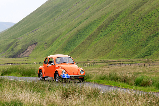 Moffat, Scotland - June 29, 2019: 1973 Volkswagen Beetle car in a classic car rally en route towards the town of Moffat, Dumfries and Galloway