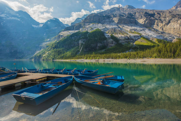 Blue Boats and Reflections Kandersteg / Switzerland lake oeschinensee stock pictures, royalty-free photos & images