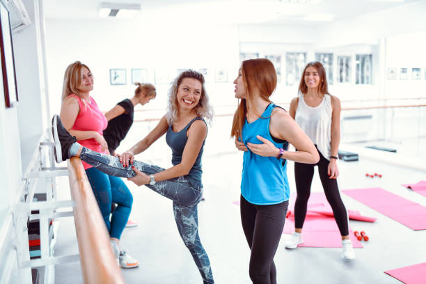 istock Females Discussing Cup Size In Gym While Stretching For Workout 1250426669