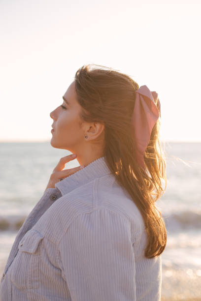 istock Young beautiful woman posing on summer beach. 1250427931