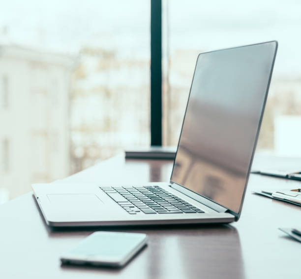 istock side view. open laptop on the office Desk 1250428815