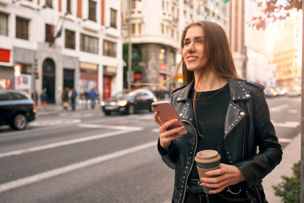 istock Blonde girl smiling with cellphone and coffee. 1250431805