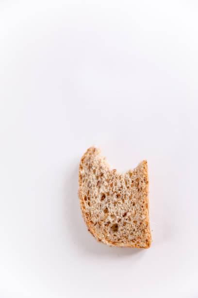 istock A bitten piece of bread with cereals on a white background 1250432029