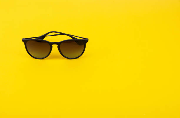 istock Stylish Sunglasses on Bright Yellow Background 1250432114