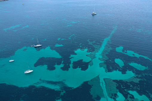 Aerial view of a paradisiacal sea with boats.
