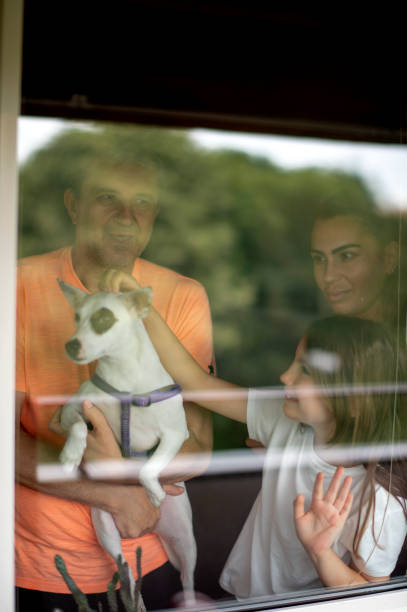istock Beautiful  family looking through window 1250435043