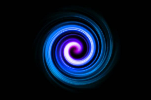 Blue fire light flying in circle with purple lights in motion on black sky background