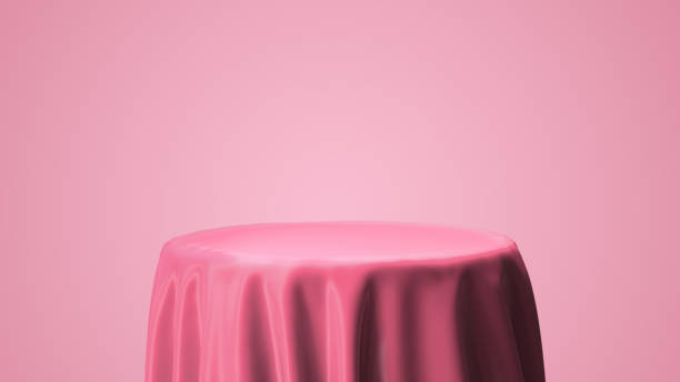 istock Pink satin drop on the circle table for model package presentation and pink background with 3d rendering include alpha clipping path. 1250436581
