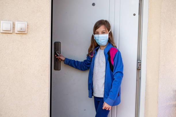 istock Cute small girl going outside with protective mask on face 1250437529