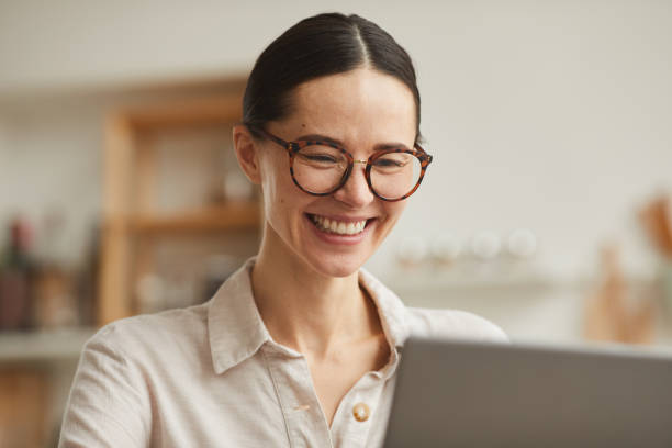 istock Smiling Businesswoman Using Laptop at Home 1250438595