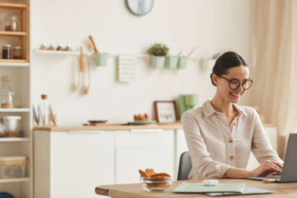 istock Smiling Young Woman Working from Home 1250438604