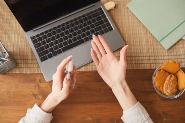 istock Top Down View at Young Woman Sanitizing Hands 1250438622