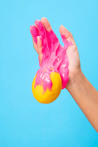 istock Hand Holding Sliced  lemon on blue paper background. 1250439046