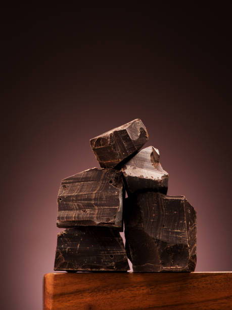 istock Closeup pieces dark chocolate on wooden board 1250441278