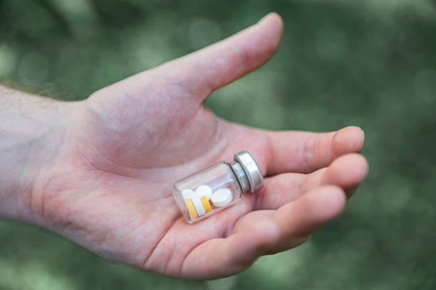 istock The person holds a closed bottle with tablets in his hand 1250444274
