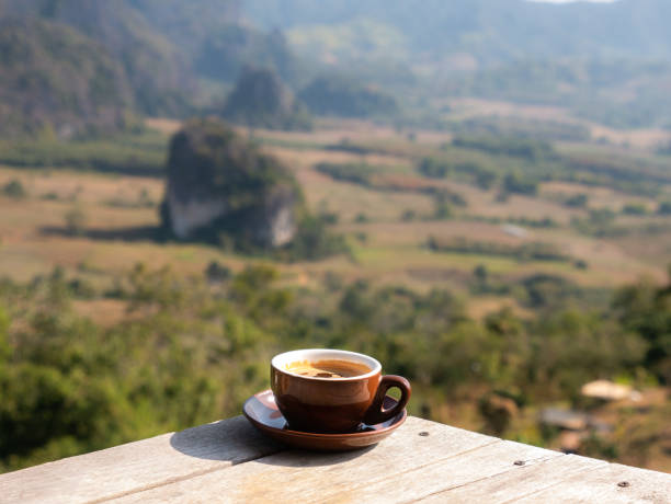 istock Cofffee Cup on The Wooden Table behind The Mountain 1250444709