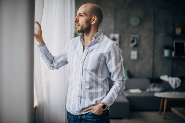 istock Young businessman looking through the window 1250448368