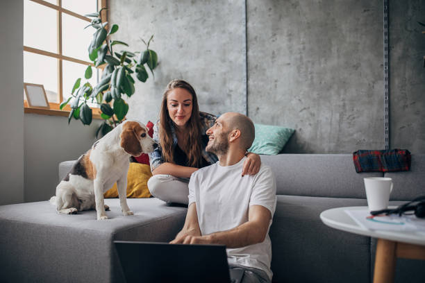 istock Girlfriend and beagle dog keeps a young man company while he working on laptop 1250449970