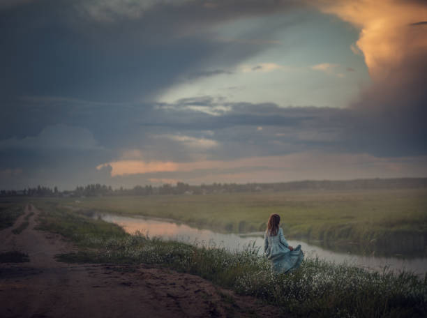 istock Little girl walks in the field. Image with selective focus. 1250452001