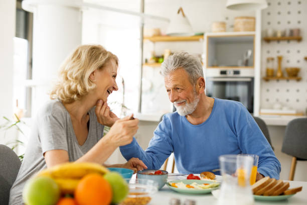 istock Happy senior couple discussing while having breakfast 1250452123