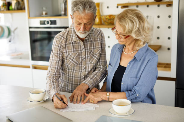 istock Senior couple checking their bills over coffee in the kitchen 1250452253