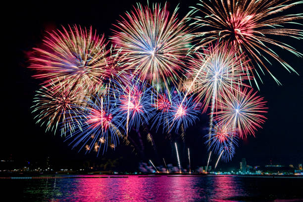 istock Beautiful colorful firework display over sea on celebration night. Firework festival showing on independence day or happy new year. 1250455170