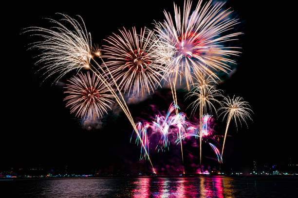 istock Beautiful colorful firework display over sea on celebration night. Firework festival showing on independence day or happy new year. 1250455171