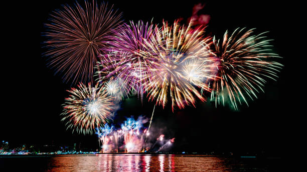 istock Beautiful colorful firework display over sea on celebration night. Firework festival showing on independence day or happy new year. 1250455191