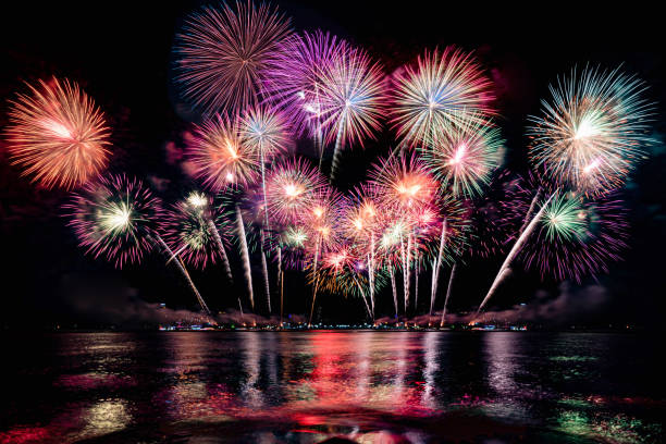 istock Beautiful colorful firework display over sea on celebration night. Firework festival showing on independence day or happy new year. 1250455204