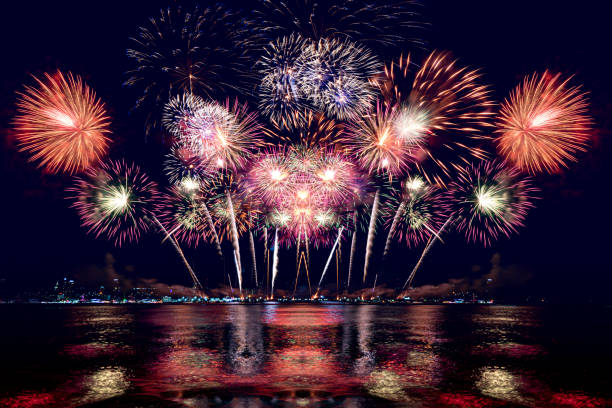 istock Beautiful colorful firework display over sea on celebration night. Firework festival showing on independence day or happy new year. 1250455213