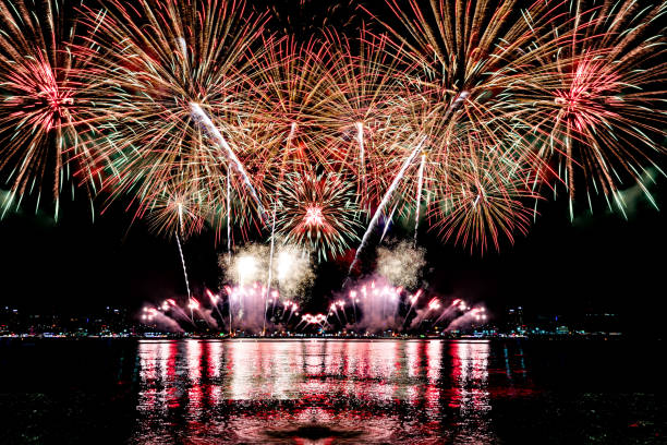 istock Beautiful colorful firework display over sea on celebration night. Firework festival showing on independence day or happy new year. 1250455243