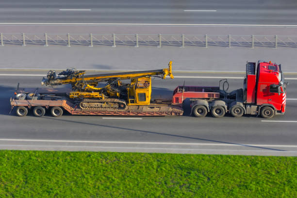 Transportation of special equipment horizontal directional drilling machines, machine for Installing underground pipe along a prescribed bore path soil surface on trailer platform of truck
