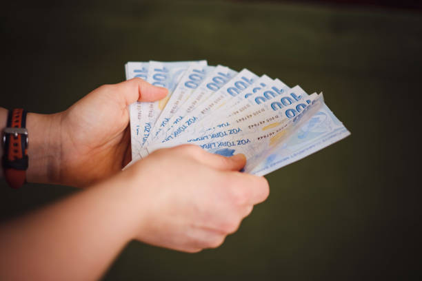 Hand holding hundred Turkish money Banknote stock photo
