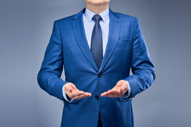 istock Businessman in a blue suit on a gray-blue background 1250461911