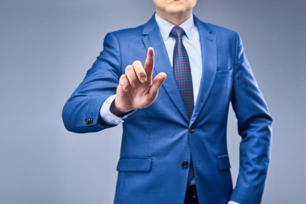 istock Businessman in a blue suit on a gray-blue background 1250461942