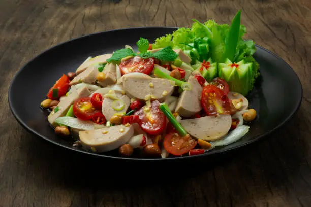 Spicy Vietnamese Pork Sausage Salad with Vegetables GoodTasty Appetizer Healthyfood or diet The Most Popular Thai &Vietnamese Food Fusion Style decorate Vegetables and cucumber sideview