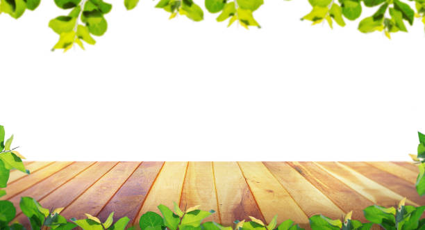 istock Brown blank wooden table top with spring green leaves as frame and free space for text or montage your products. 1250463297