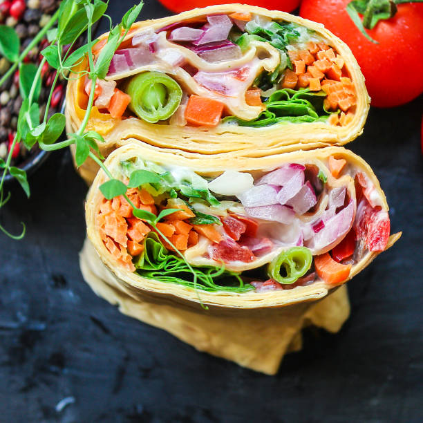 wrap tortilla or burrito stuffing vegetables vegetarian pita bread Menu concept serving size. food background top view copy space for text organic healthy eating