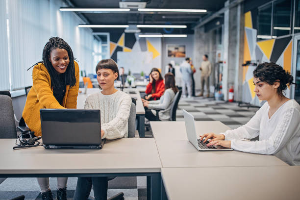 istock Beautiful women working together in big modern office 1250464893