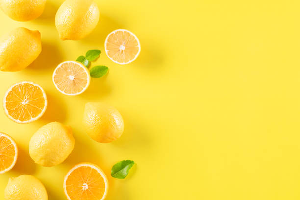 istock Summer composition made from oranges, lemon and green leaves on pastel yellow background. Fruit minimal concept. Flat lay, top view, copy space. 1250464932