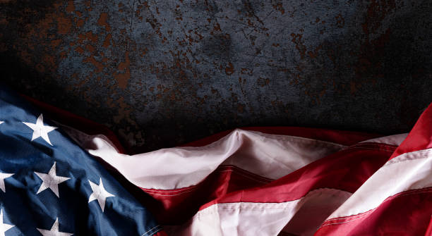 istock Happy Independence Day. American flags  against dark stone background. July 4. 1250464962
