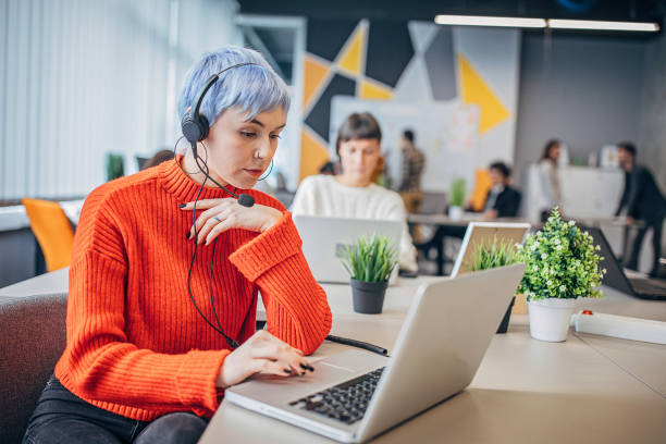 istock Woman with headset in big modern office 1250465143
