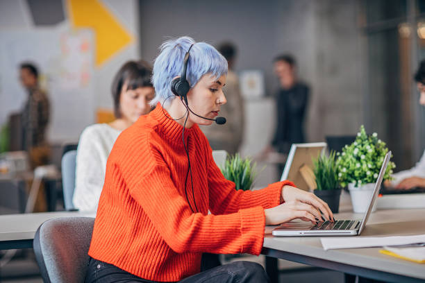 istock Woman with headset in big modern office 1250465218