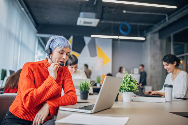 istock Woman with headset in big modern office 1250466601