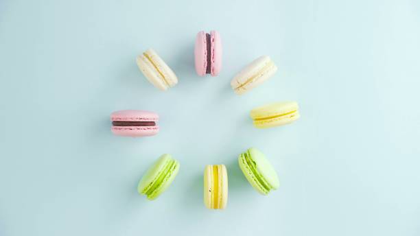 Macaroons or macaron on pastel blue surface. Close up.