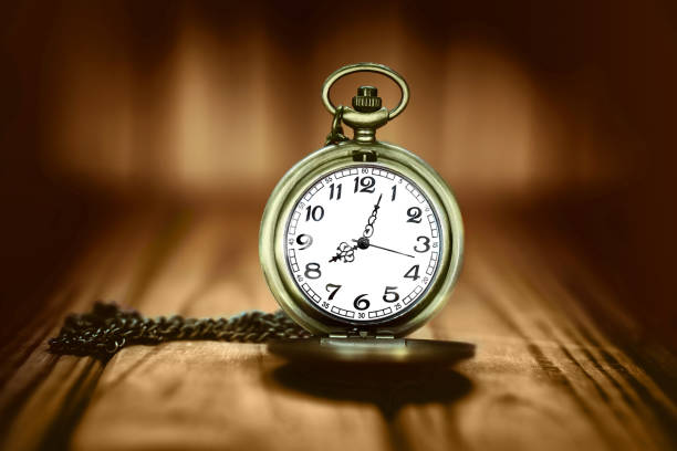 istock Vintage pocket watch on a wooden background. Selective focus 1250466954