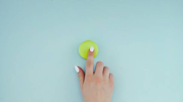 istock Green Macaroons or macaron on pastel blue surface. Close up. 1250467021