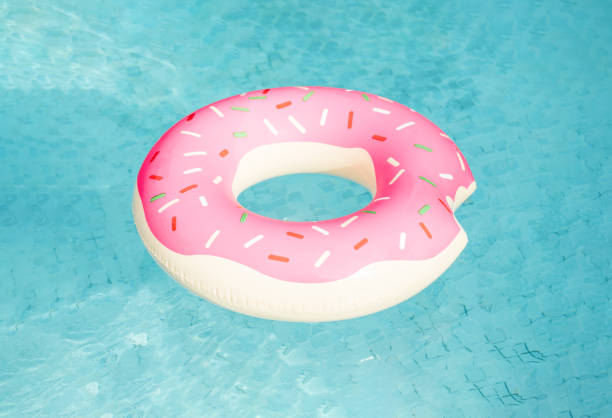 istock Inflatable swimming ring in shape of donut floating in pool 1250467338