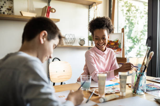 istock Creative kids enjoying making art with watercolors at home 1250468231